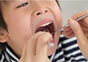 Kid receiving dental checkup