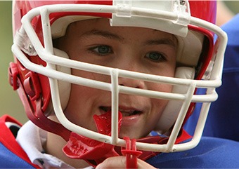 Child placing mouthguard