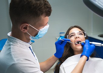 A dentist performing a root canal on a patient