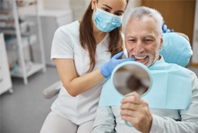 a dental hygienist showing a patient their smile