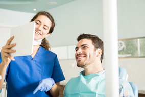 Patient discusses dental implants with dentist