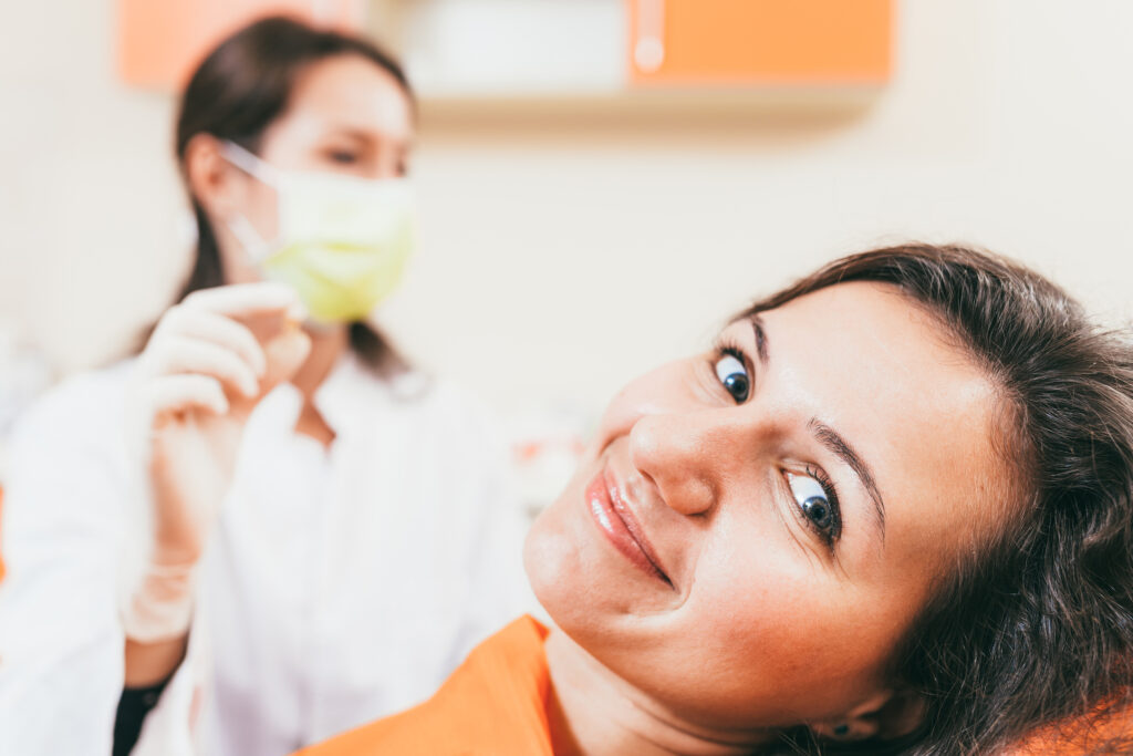 Patient smiling after a tooth extraction